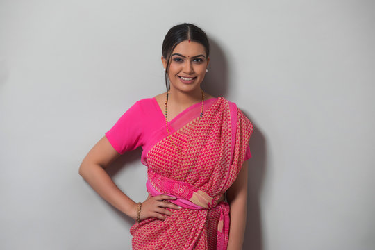 young woman in saree smiling 	