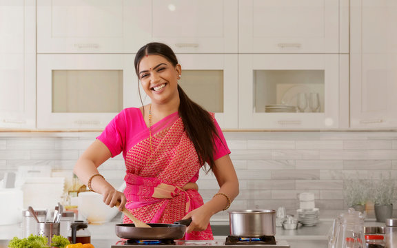 woman in saree cooking in the kitchen	
