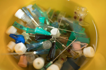 needles and syringes in disinfectant. disposal of medical needles and syringes and medical waste