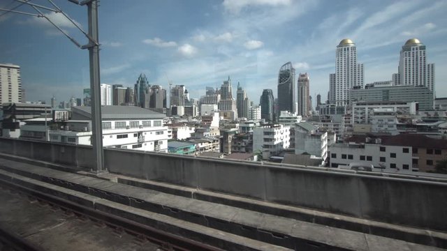 The city view out of the window of a moving train