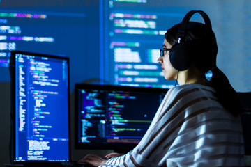 Software developer freelancer woman female in glasses work with program code C++ Java Javascript on...