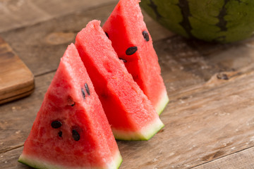 Fresh sliced watermelon on wooden background