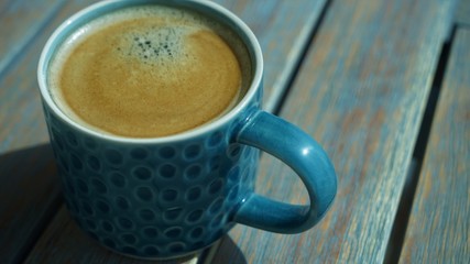 close up view on ceramic blue cup of coffee