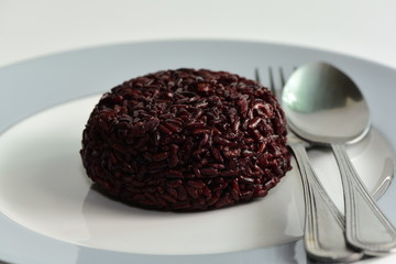 Cooked rice berry in plate on white background