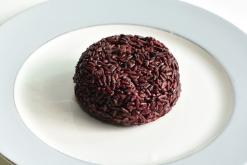 Cooked rice berry in plate on white background
