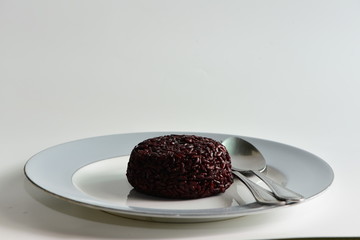 Cooked rice berry in plate on white background
