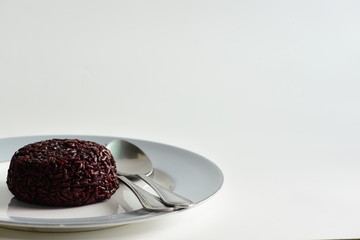 Cooked rice berry in plate on white background