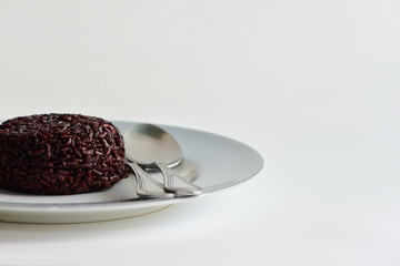 Cooked rice berry in plate on white background