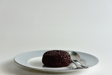 Cooked rice berry in plate on white background
