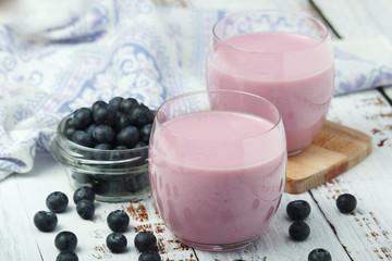Two glasses with blueberry yogurt	