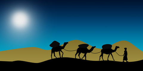 Fototapeta na wymiar Camel caravan going through the sand dunes