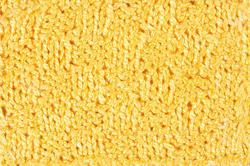 Hand knitting yellow background. Vintage pattern of rustic hand knitting of the middle of the last century. Yellow vintage wool close up background and texture