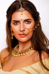 Portrait of beautiful indian girl. beauty portrait. Young hindu woman model with kundan jewelry set. Close up. Traditional India costume lehenga choli or sari. make-up 