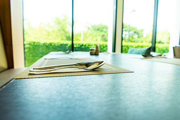 Fototapeta premium spoon set Tableware big windows at the background