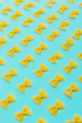 Pattern of pasta bow on blue background. Beautiful italian food meal.