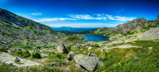 Beautiful panoramic view with tarn mountain lake and sayan mountain range in Ergaki national park during summer day, Siberia, Russia