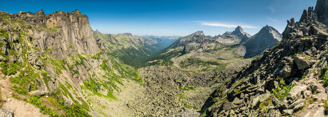 Naklejka premium Gorgeous panoramic view on top of western Sayan mountain range during summer sunny day in Ergaki national park, Siberia, Russia