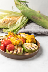 From above grilled  vegetables on dish over white background