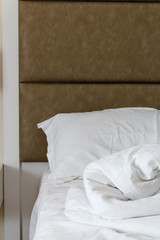 Fototapeta na wymiar White color bedroom, pillow and bed linen