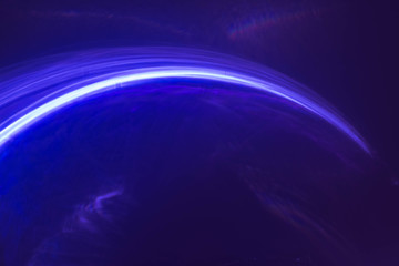 Blur neon blue arc lines, strokes. Bright falling comet light, glowing rays. Purple abstract art...