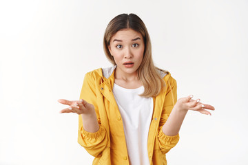 What wrong. Ambushed shocked confused young asian girl coworker shrugging hands spread sideways...