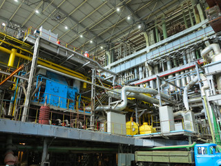 Industrial big water pumps with electric motors, pipes, tubes, equipment and steam turbine at power plant