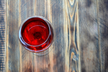 Red wine in glasses on a wooden background