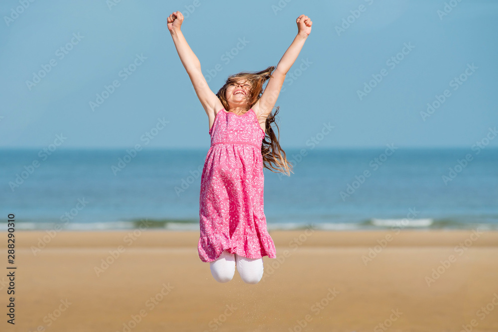 Poster pretty young girl doing antics on the beach