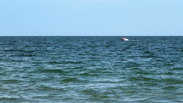 Man is swimming in an inflatable boat in the Black Sea