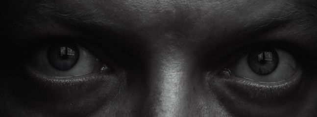 Macro eyes portrait. Evil human look. Scary anger eyes.