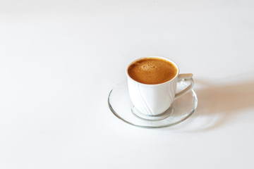 White cup of coffee on white background	