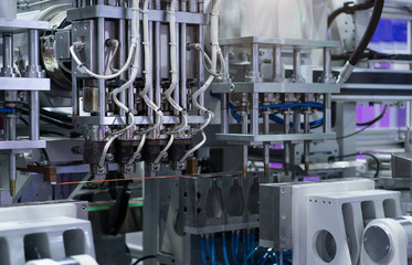 Picture of the plastic industrial machine that is working.