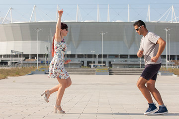 Street couple dancers performing Argentine tango dance