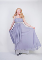 Young mix race happy adult woman in a grey long shiffon evening wear