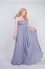 Young mix race happy adult woman in a grey long shiffon evening wear