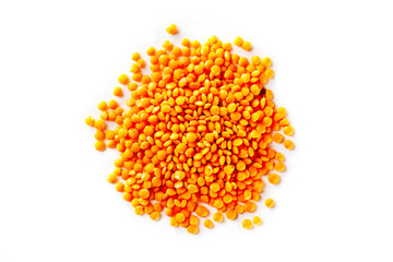 Macro top view image of red lentil pile isolated at white background.