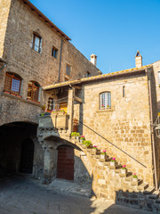 Fototapeta na wymiar old stone houses in narrow streets in the old town of Viterbo, Italy