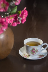 cup of tea and pink flowers