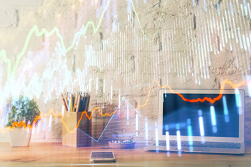 Financial chart drawing and table with computer on background. Double exposure. Concept of international markets.