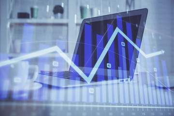 Forex Chart hologram on table with computer background. Multi exposure. Concept of financial markets.