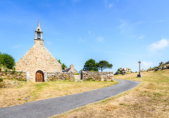Front view of the granite chapel of Saint-Nicolas in Bugueles, Brittany, France, with its walled...