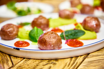 Meatballs with sauce are on the plate