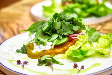 Fried fish with parsley, lettuce, cucumbers and Tartar sauce
