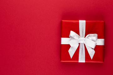 Fototapeta na wymiar Christmas, holiday present box on red background.