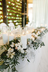 Candles on the wedding table photographed from the side