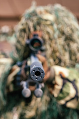 Camouflaged sniper keeps victim at gunpoint