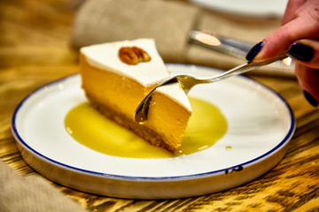 Cheesecake with walnuts on the plate.