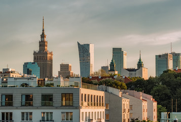 Warsaw skyline with Palace of Culture and Science and modern skyscrapers at sunset