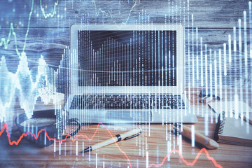 Double exposure of graph and financial info and work space with computer background. Concept of international online trading.