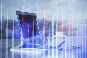 Stock market graph and table with computer background. Double exposure. Concept of financial analysis.
